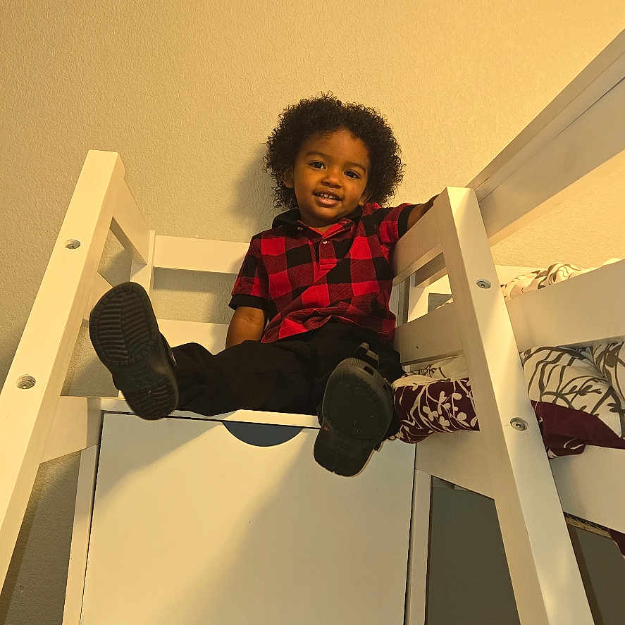 Demari joined the competition — help win amazing prizes! bed, bedroom, boy, bunkbed, child, clothing, crib, drawer, face, footwear, furniture, head, indoors, infantbed, male, pants, person, photography, portrait, shoe