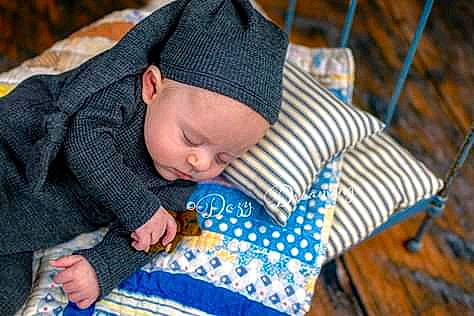 Arrow is registered to the contest to win money with this photo: baby, beanie, child, headgear, headwear, knitting, nap, person, sleep, toddler, wool