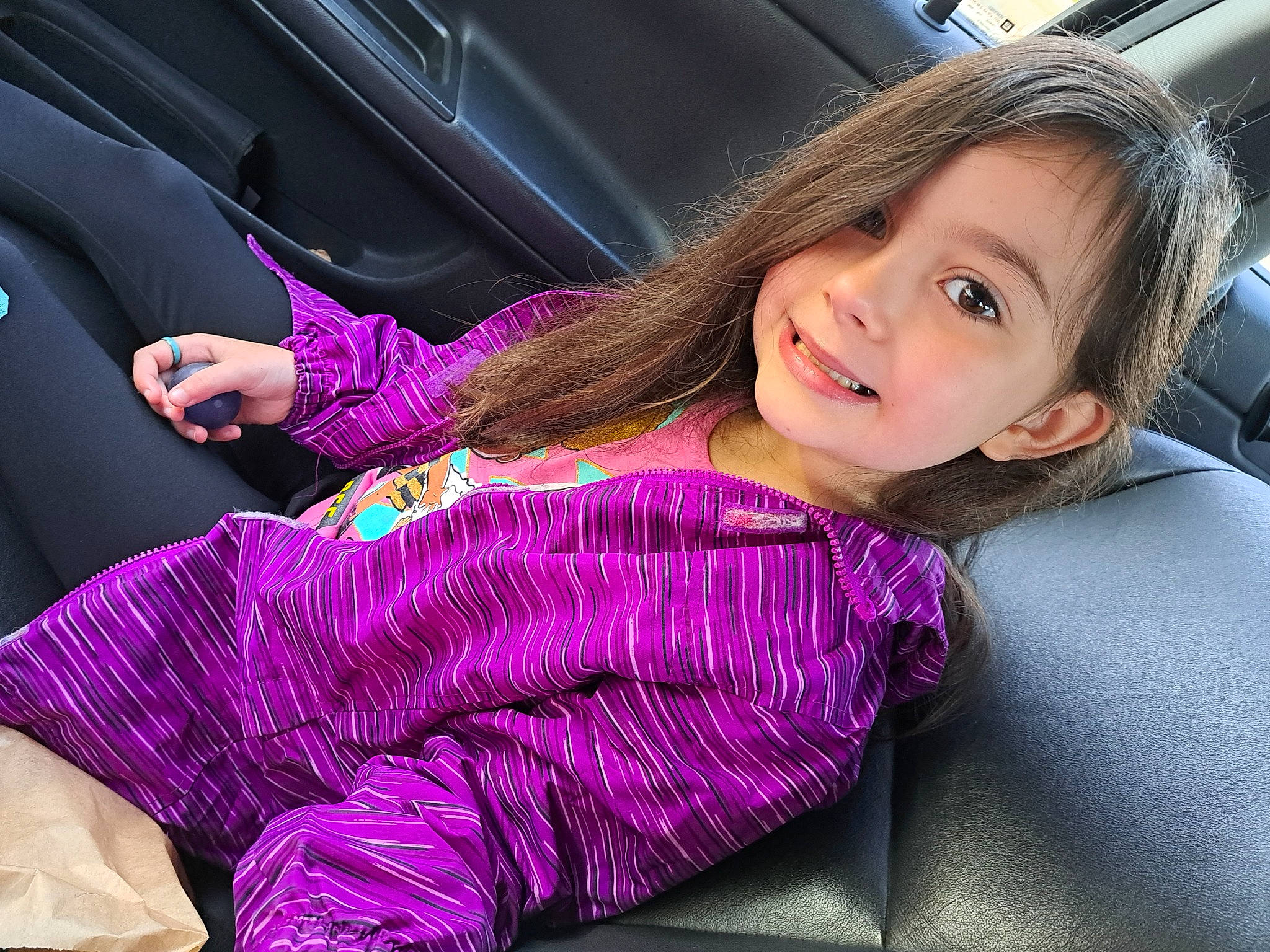 Joni-mae joined the competition — help win amazing prizes! auto_part, automotive_design, automotive_exterior, comfort, finger, hand, joy, leisure, long_hair, magenta, motor_vehicle, person, pink, purple, skin, sleeve, smile, steering_wheel, toddler, vehicle