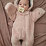 Marley is registered to the contest to win money with this photo: baby, infant, pacifier, pink_onesie, fluffy_clothing, bear_ears, hooded_outfit, soft_blanket, cute, lying_down, child, portrait, indoor, warm_clothing, adorable, face, head, person, baby_clothes, cozy