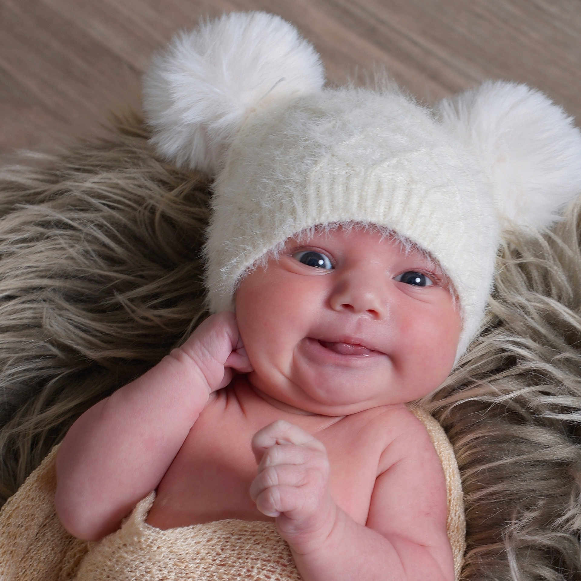 Marley is registered to the contest to win money with this photo: baby, chubby_cheeks, cozy, cute, expression, face, fur_blanket, hand, hat, indoors, infant, knit_hat, lying_down, newborn, pom_poms, portrait, skin, soft_texture, tongue, warm