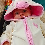 Lyciana a rejoint le concours — aidez-le/la à gagner de superbes lots ! baby, infant, onesie, unicorn, hood, pink, white, face, eyes, cushion, blanket, cozy, clothing, child, indoor, cute, soft, portrait, young, babywear