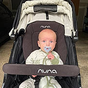 Jaxson joined the competition — help win amazing prizes! baby, pacifier, stroller, nuna, infant, clothing, face, blue_eyes, sitting, child, indoor, garage, seat_belt, fabric, person, young_child, cute, portrait, baby_clothes, transport
