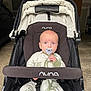 Jaxson joined the competition — help win amazing prizes! baby, pacifier, stroller, nuna, infant, clothing, face, blue_eyes, sitting, child, indoor, garage, seat_belt, fabric, person, young_child, cute, portrait, baby_clothes, transport