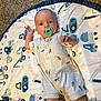 Jaxson joined the competition — help win amazing prizes! baby, infant, pacifier, romper, dog_pattern, play_mat, construction_vehicles, carpet, indoor, child, cute, lying_down, looking_at_camera, hand_raised, blue, white, patterned_clothing, soft_texture, floor, toddler