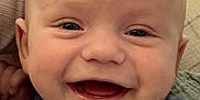 Jaxson joined the competition — help win amazing prizes! baby, smiling, face, closeup, infant, blue_clothing, happy, child, cute, portrait, young, skin, head, eyes, mouth, expression, indoors, fabric, person, newborn