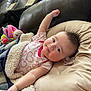 Leah is registered to the contest to win money with this photo: baby, infant, blanket, pillow, pacifier, toy, heart_pattern, onesie, cozy, relaxed, indoor, couch, child, cute, pink, skin, face, arm, laying, furniture
