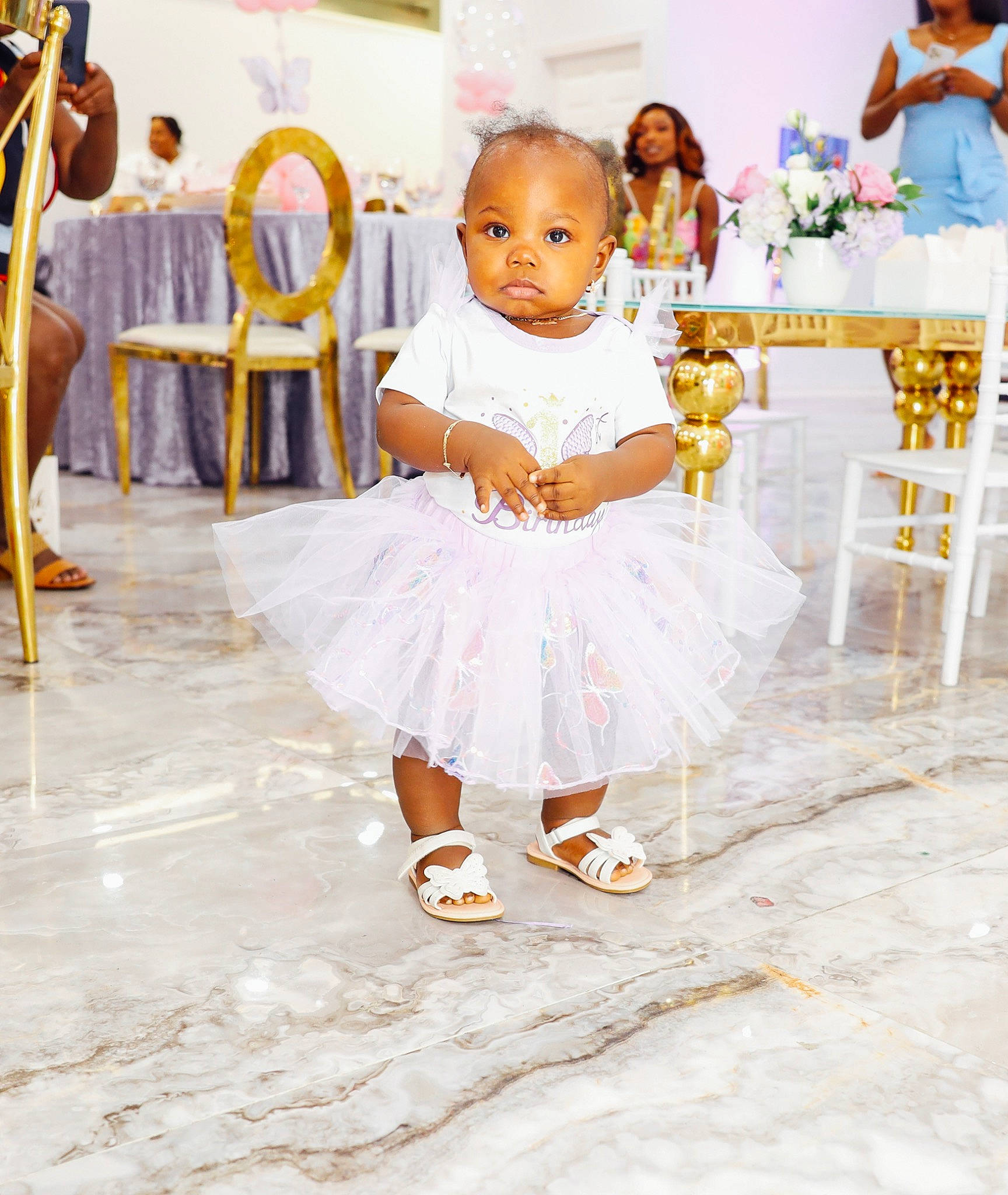 Khai-el joined the competition — help win amazing prizes! baby, baby_toddler_clothing, blurred, ceremony, chair, child, dress, event, flooring, fun, furniture, gown, happy, person, sandal, sitting, table, toddler, tradition, vacation