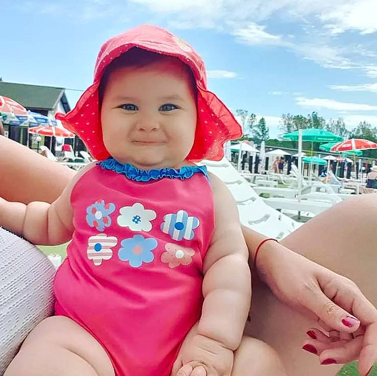 Daria is registered to the contest to win money with this photo: baby_toddler_clothing, blue, cloud, cool, face, facial_expression, finger, happy, head, headwear, joy, leisure, mouth, person, pink, product, skin, sky, sleeve, smile