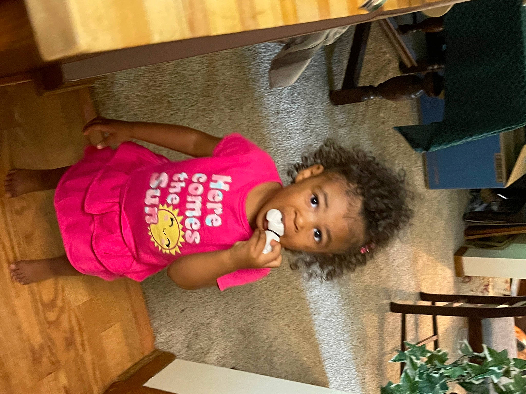 Kinsley is registered to the contest to win money with this photo: baby_toddler_clothing, child, flooring, fun, happy, hardwood, hat, magenta, person, room, t_shirt, toddler, wood