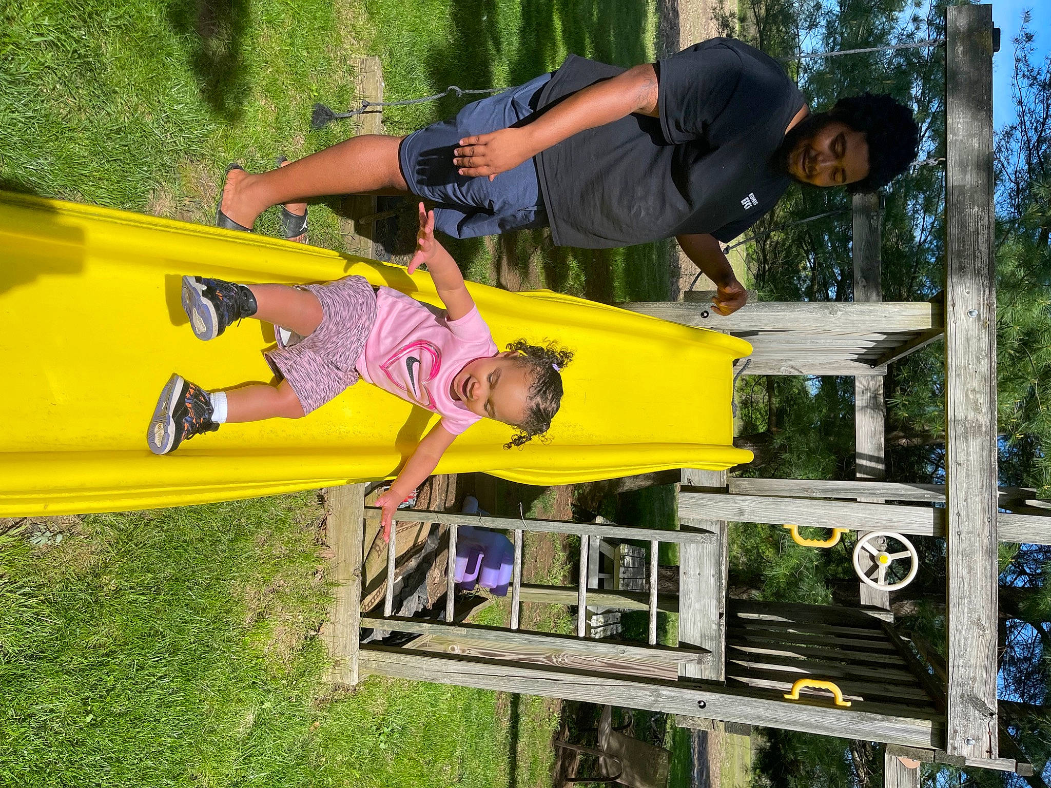 Zyla is registered to the contest to win money with this photo: automotive_exterior, fun, grass, happy, joy, leisure, natural_environment, person, plant, recreation, shorts, smile, t_shirt, tree