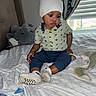 Jace is registered to the contest to win money with this photo: baby, beanie, bed, bedroom, blanket, child, clothing, curtains, cute, elephant, hat, indoors, infant, plush_toy, portrait, shirt, sitting, socks, trousers, window
