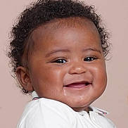Jacob is registered to the contest to win money with this photo: baby, infant, smiling, curly_hair, face, drool, white_clothing, portrait, closeup, happy, child, cute, skin, eyes, mouth, head, young, background, studio, person