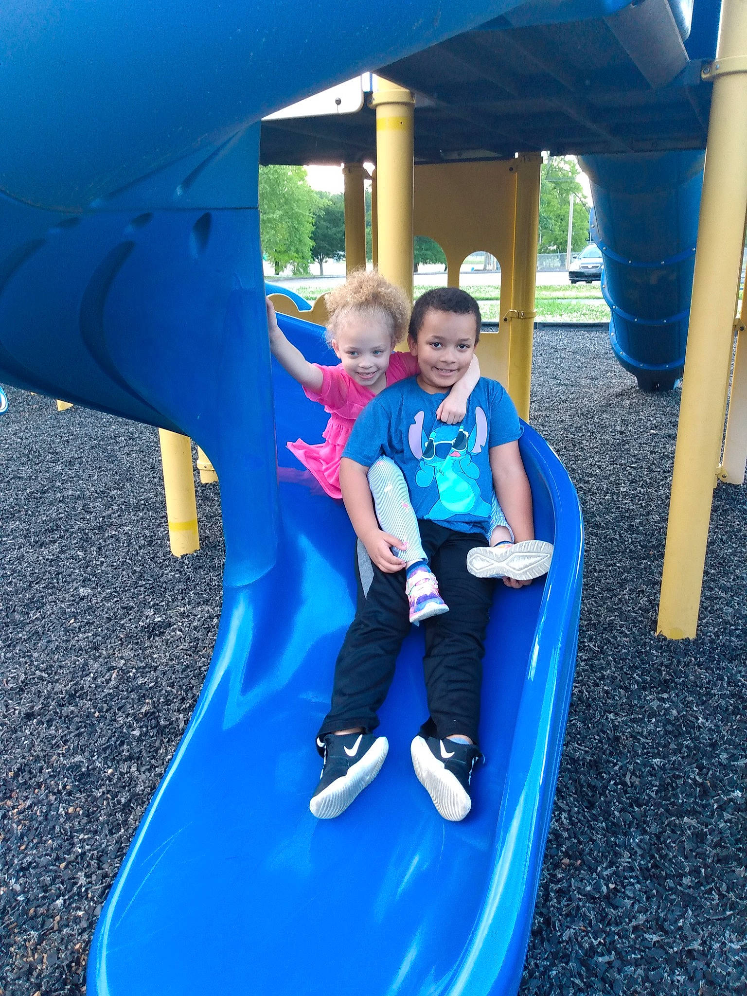 Abigail is registered to the contest to win money with this photo: blue, child, chute, city, fun, games, human_settlement, inflatable, joy, leisure, outdoor_play_equipment, person, play, playground, playground_slide, public_space, recreation, smile, vacation