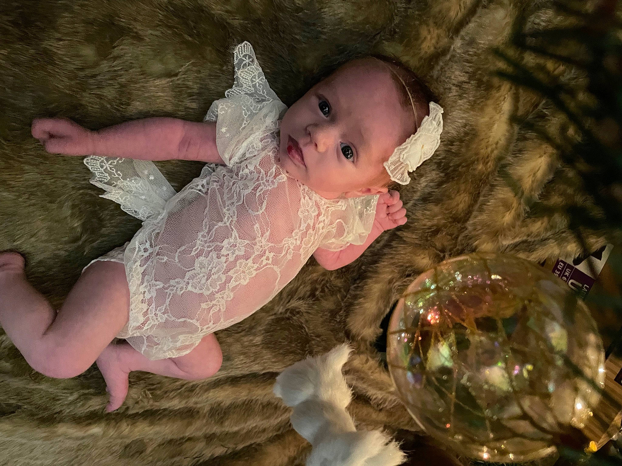 Lavender is registered to the contest to win money with this photo: baby, baby_toddler_clothing, barefoot, bridal_accessory, child, dress, embellishment, event, fashion_accessory, flash_photography, fun, grass, hair_accessory, happy, headpiece, ornament, people_in_nature, person, sitting, toddler