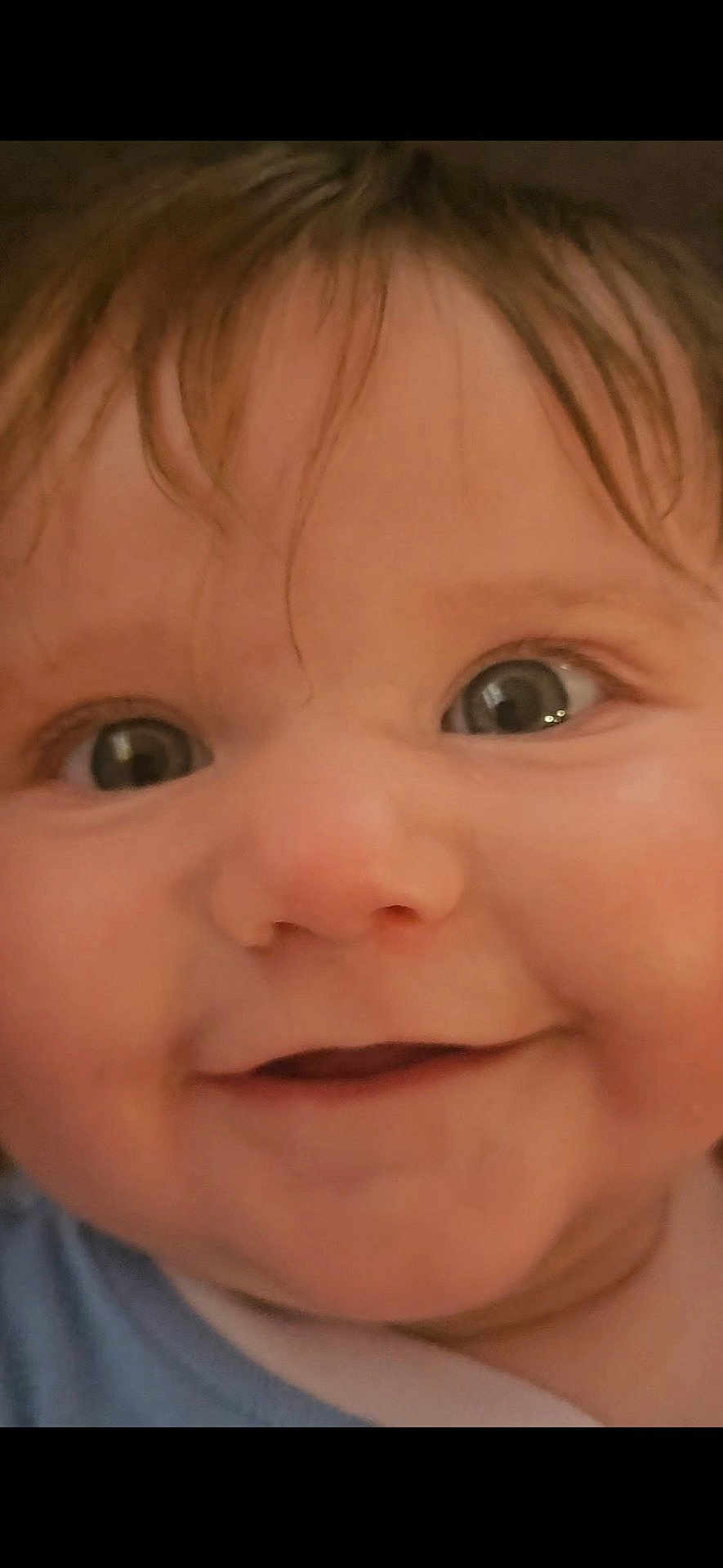 Sophie is registered to the contest to win money with this photo: baby, close_up, face, eyes, smile, infant, child, skin, hair, expression, cute, portrait, young, person, cheeks, nostrils, mouth, eyebrows, innocence, curiosity