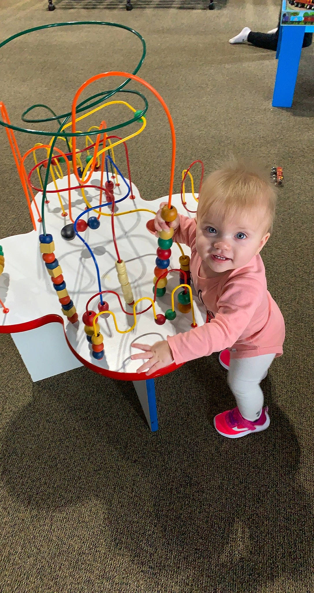 Lily is registered to the contest to win money with this photo: art, baby, baby_products, baby_toddler_clothing, baby_toys, child, circle, event, fun, leisure, person, play, recreation, smile, toddler, toy, visual_arts, wire
