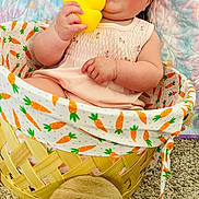 Harper joined the competition — help win amazing prizes! baby, infant, child, basket, carrot_pattern, rubber_duck, toy, smiling, happy, cute, sitting, pink_dress, quilt, carpet, indoor, portrait, face, hand, cheeks, young