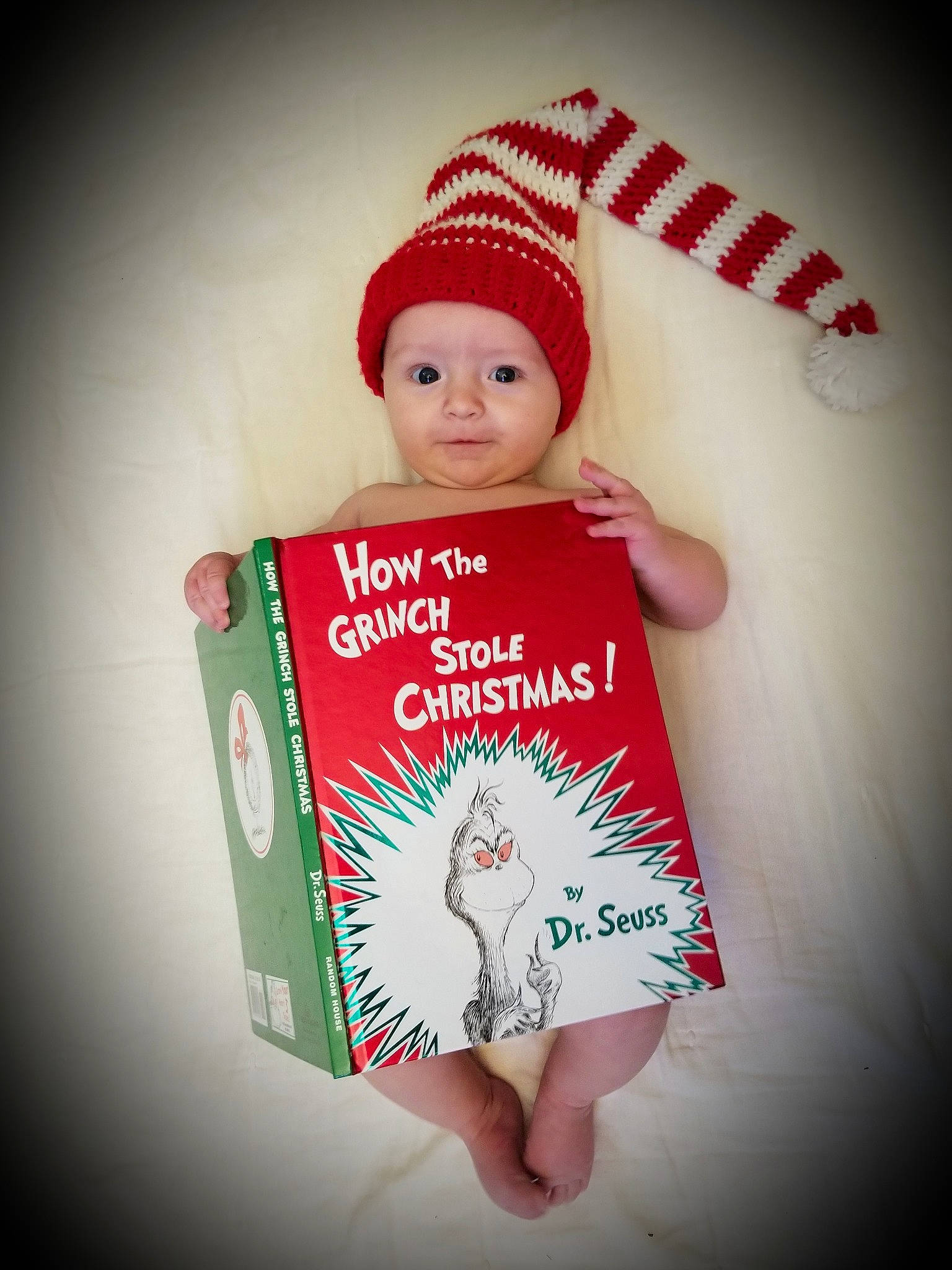 Theodore is registered to the contest to win money with this photo: baby, child, christmas, fictional_character, finger, hand, happy, head, headgear, person, red, smile