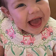 Kambry joined the competition — help win amazing prizes! baby, child, infant, smiling, laughing, portrait, face, indoor, close_up, happy, joyful, sitting, clothing, dress, patterned_outfit, floral, vehicles, pink, brown_hair, photography