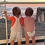 Elino Et Enoha participe au concours pour gagner de l'argent avec cette photo : back_view, balcony, barefoot, building, child, diaper, glass_railing, nature, ocean, outdoor, overalls, sea, shirt, sky, standing, sunset, tile_floor, toddler, two_children, view