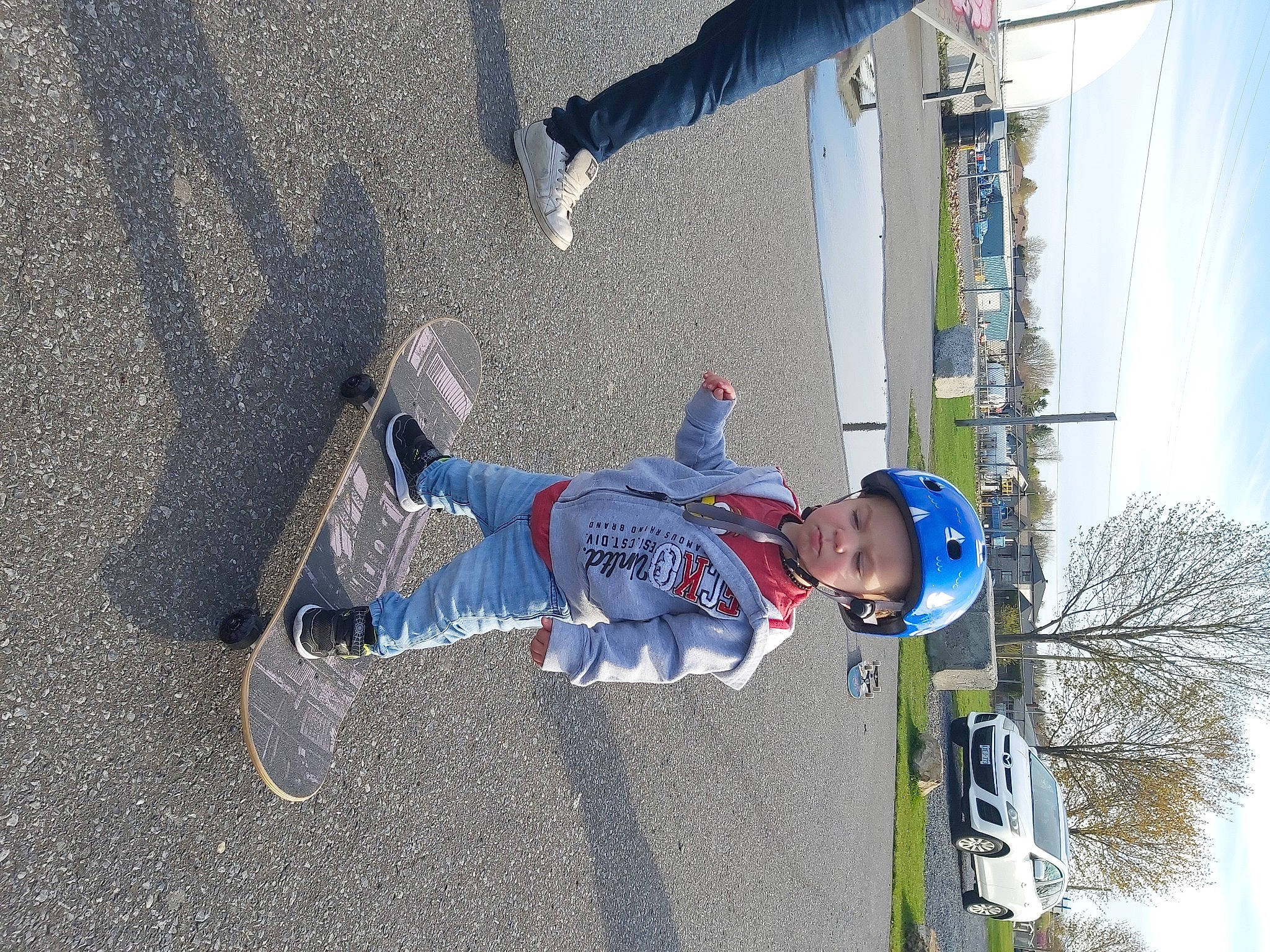 Kreed is registered to the contest to win money with this photo: adventure, asphalt, cloud, concrete, denim, electric_blue, fun, headwear, jeans, leisure, outdoor_shoe, person, recreation, road_surface, sidewalk, sky, slope, toddler, tree, trousers