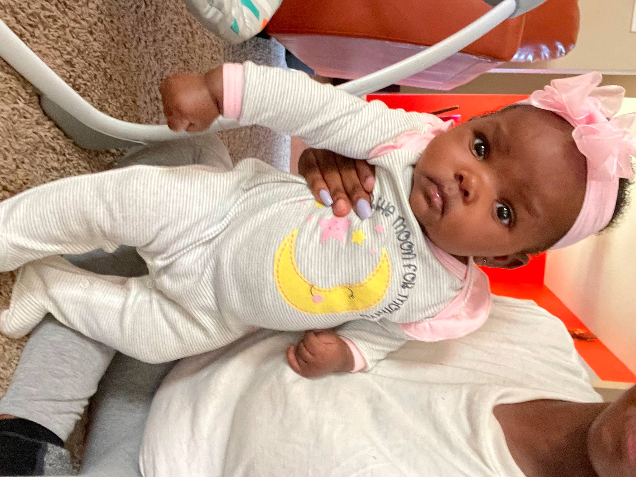 Layniesha is registered to the contest to win money with this photo: baby, baby_products, baby_toddler_clothing, cheek, child, comfort, elbow, foot, happy, human_leg, knee, lap, person, room, sitting, sock, thigh, toddler, white