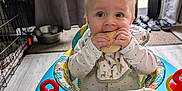 Wyatt is registered to the contest to win money with this photo: baby, bib, blue, child, curious, curtain, door, floor, home, indoor, infant, mat, playtime, red, shoes, toy, walker, white, window, wooden_floor