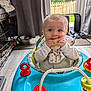 baby, bib, blue, child, curious, curtain, door, floor, home, indoor, infant, mat, playtime, red, shoes, toy, walker, white, window, wooden_floor