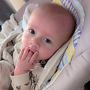 Wyatt joined the competition — help win amazing prizes! baby, baby_seat, blanket, blue_eyes, child, clothing, comfort, cozy, cute, expression, face, fingers, hand, indoor, infant, person, playing, portrait, resting, soft