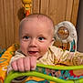 Wyatt is registered to the contest to win money with this photo: activity_center, baby, blue_eyes, child, closeup, clothing, colorful, cute, face, grip, hand, happy, indoor, infant, person, play, smile, toy, wooden_cabinet, young
