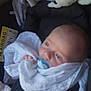 baby, pacifier, car_seat, blanket, infant, child, clothing, seatbelt, closeup, newborn, cute, sitting, face, head, comfort, indoors, safety, soft, peaceful, wrapped