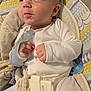 baby, infant, onesie, baby_seat, pacifier, clothing, face, hands, curious, straps, patterned, soft_toy, child, indoor, cute, looking_away, expression, small_fists, seatbelt, fabric