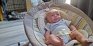 Wyatt is registered to the contest to win money with this photo: baby, baby_swing, carpet, child, clothing, comfort, curtain, cute, face, floor, furniture, home, indoor, infant, light, pacifier, person, relaxing, toy, window