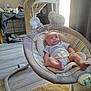 baby, infant, baby_swing, indoor, floor, carpet, curtain, window, light, clothing, face, person, furniture, toy, pacifier, relaxing, home, cute, comfort, child