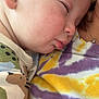 baby, sleeping, closeup, face, child, person, skin, ear, nose, tie_dye, shirt, clothing, comfort, rest, peaceful, cuddle, infant, portrait, soft, warm