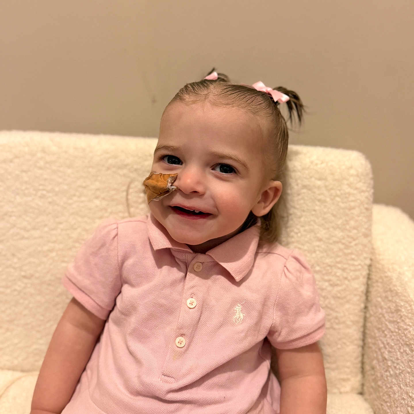 Ruby is registered to the contest to win money with this photo: baby, bodypart, chair, clothing, couch, cutlery, face, finger, furniture, hand, happy, head, homedecor, linen, person, photography, portrait, sitting, smile, spoon