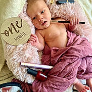 Rosie-Araya joined the competition — help win amazing prizes! baby, infant, one_month, fluffy_cushion, makeup_brush, nail_polish, mascara, eyeshadow_palette, pink_blanket, mauve_cloth, wooden_sign, milestone, cute, portrait, skin, hand, foot, cosmetics, relaxed, indoors