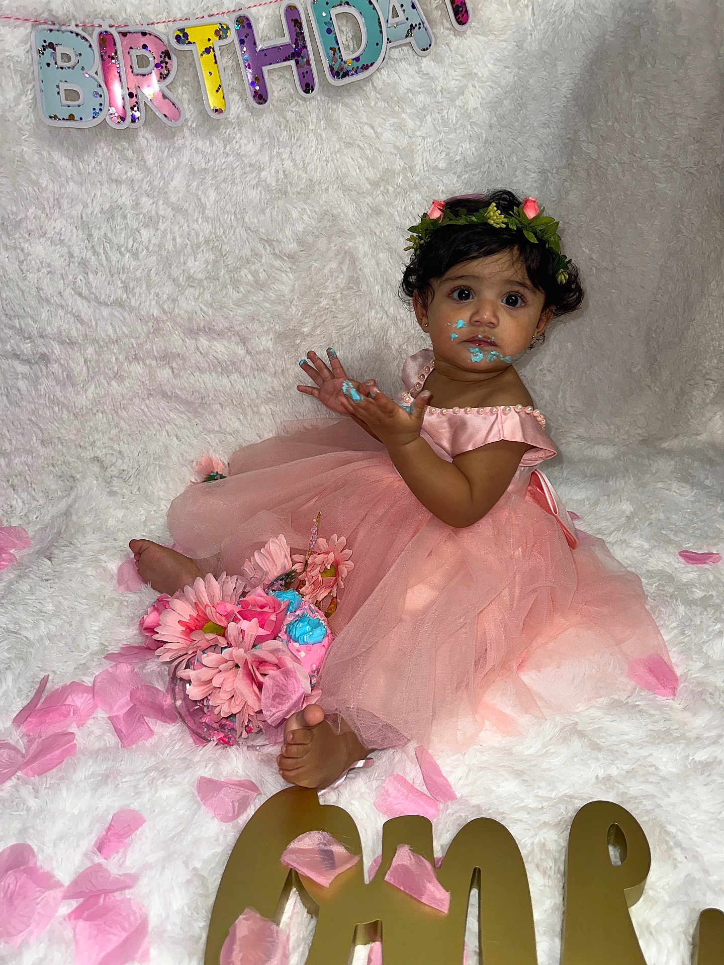 Sara Rodriguez joined the competition — help win amazing prizes! baby, birthday, cake, child, dress, flower_crown, floral, foot, girl, pink, petals, portrait, sitting, smudge, smile, toddler, white_background, celebration, decorations, cute