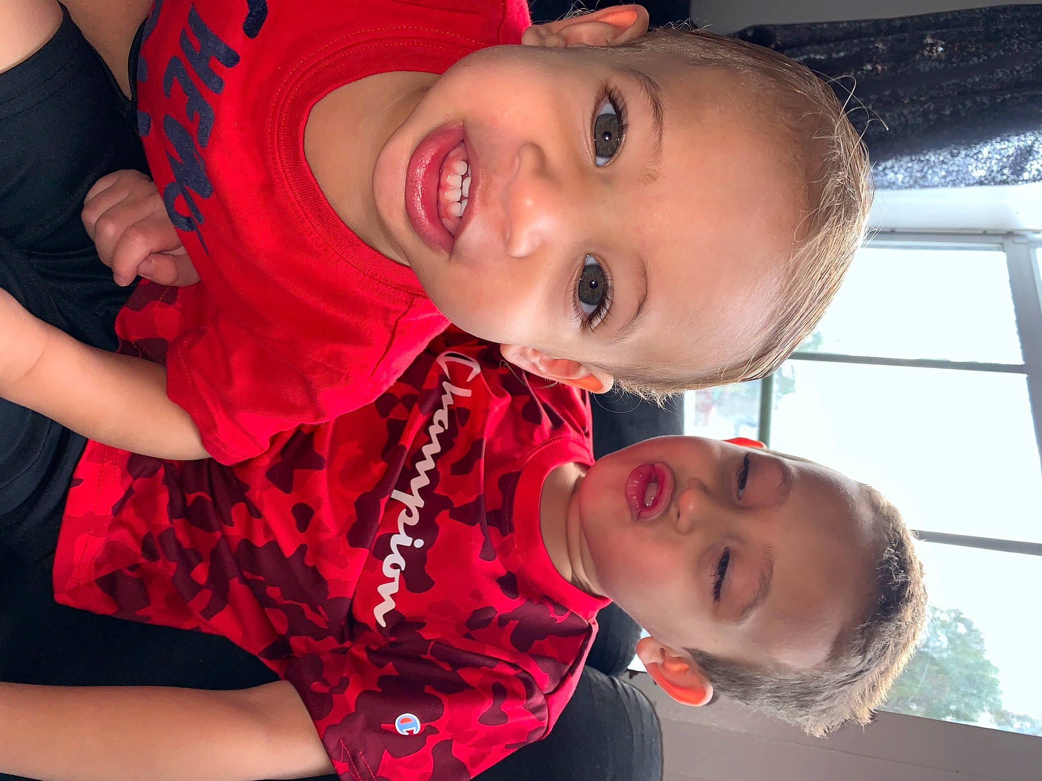 Elijah is registered to the contest to win money with this photo: arm, cheek, chin, cool, eye, eyebrow, flash_photography, gesture, happy, iris, lip, mouth, neck, nose, organ, person, red, skin, smile, toddler