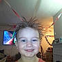 Christopher Thomas is registered to the contest to win money with this photo: child, smile, hair, spiky_hair, indoor, living_room, decoration, orange_shirt, face, happy, person, furniture, chair, table, television, picture_frame, fireplace, wall, ceiling, light
