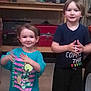 child, children, boy, girl, smile, clothing, shorts, shirt, indoor, workshop, garage, tools, shelf, storage, happy, person, standing, young, casual, clapping