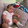 Araceli is registered to the contest to win money with this photo: baby, infant, couch, sofa, blanket, socks, onesie, indoor, child, cute, smiling, person, home, furniture, cozy, relaxed, window, lamp, portrait, soft_lighting