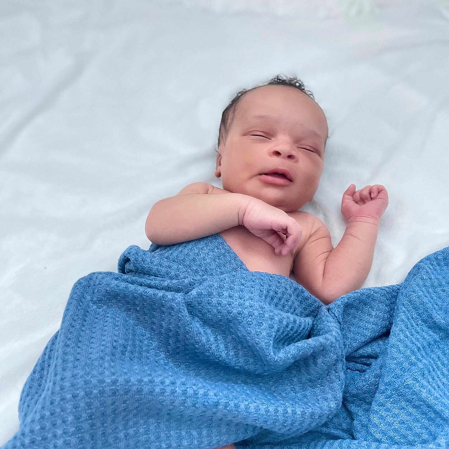 Chibugom is registered to the contest to win money with this photo: baby, blanket, blue, cozy, cute, face, hand, indoors, infant, lying_down, newborn, peaceful, portrait, resting, skin, sleeping, soft, toddler, white_background, wrapped