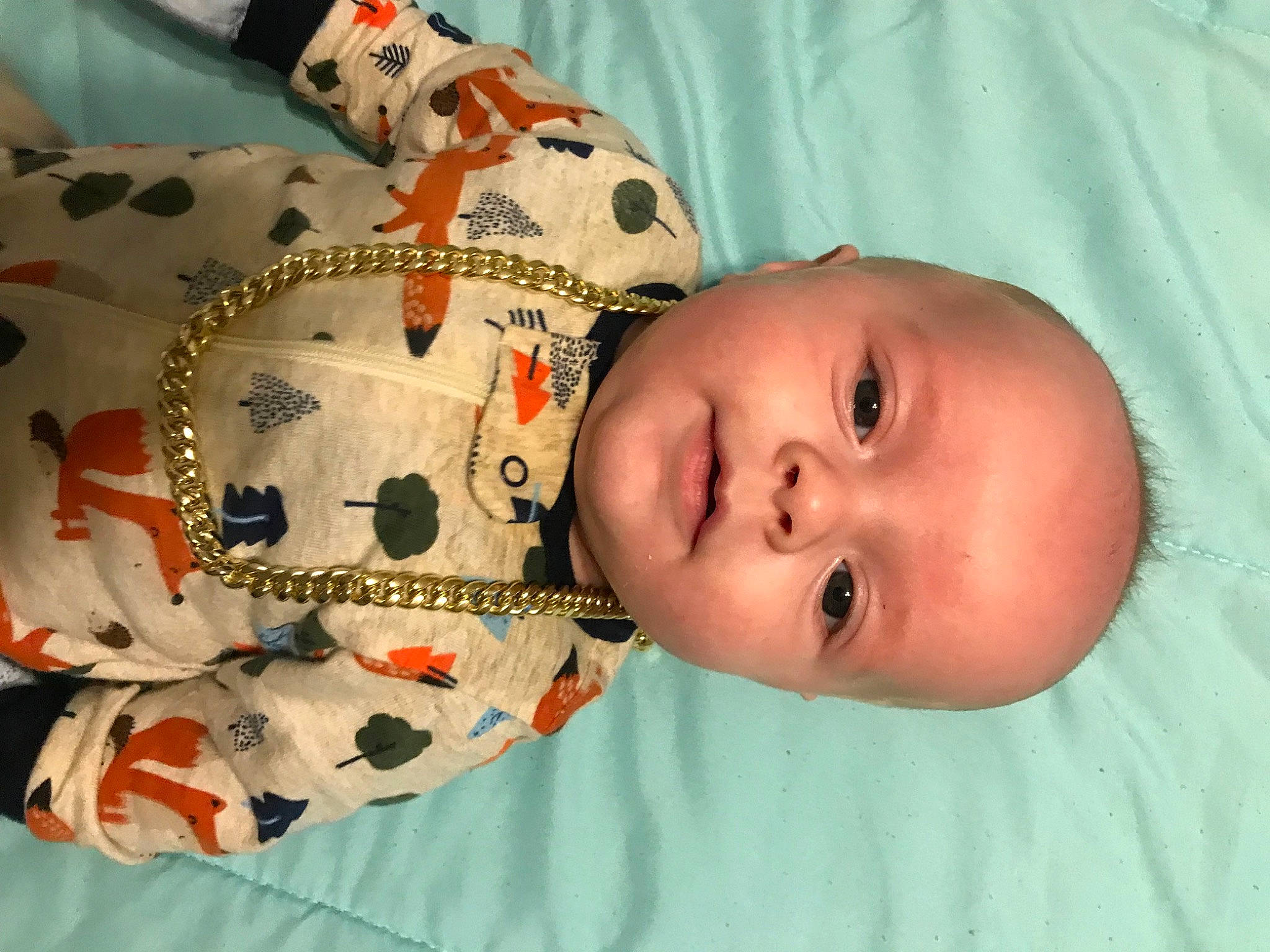 Kashton is registered to the contest to win money with this photo: arm, baby, baby_products, baby_toddler_clothing, cheek, child, eye, face, happy, head, linens, nose, organ, pattern, person, skin, sleeve, smile, stuffed_toy, textile
