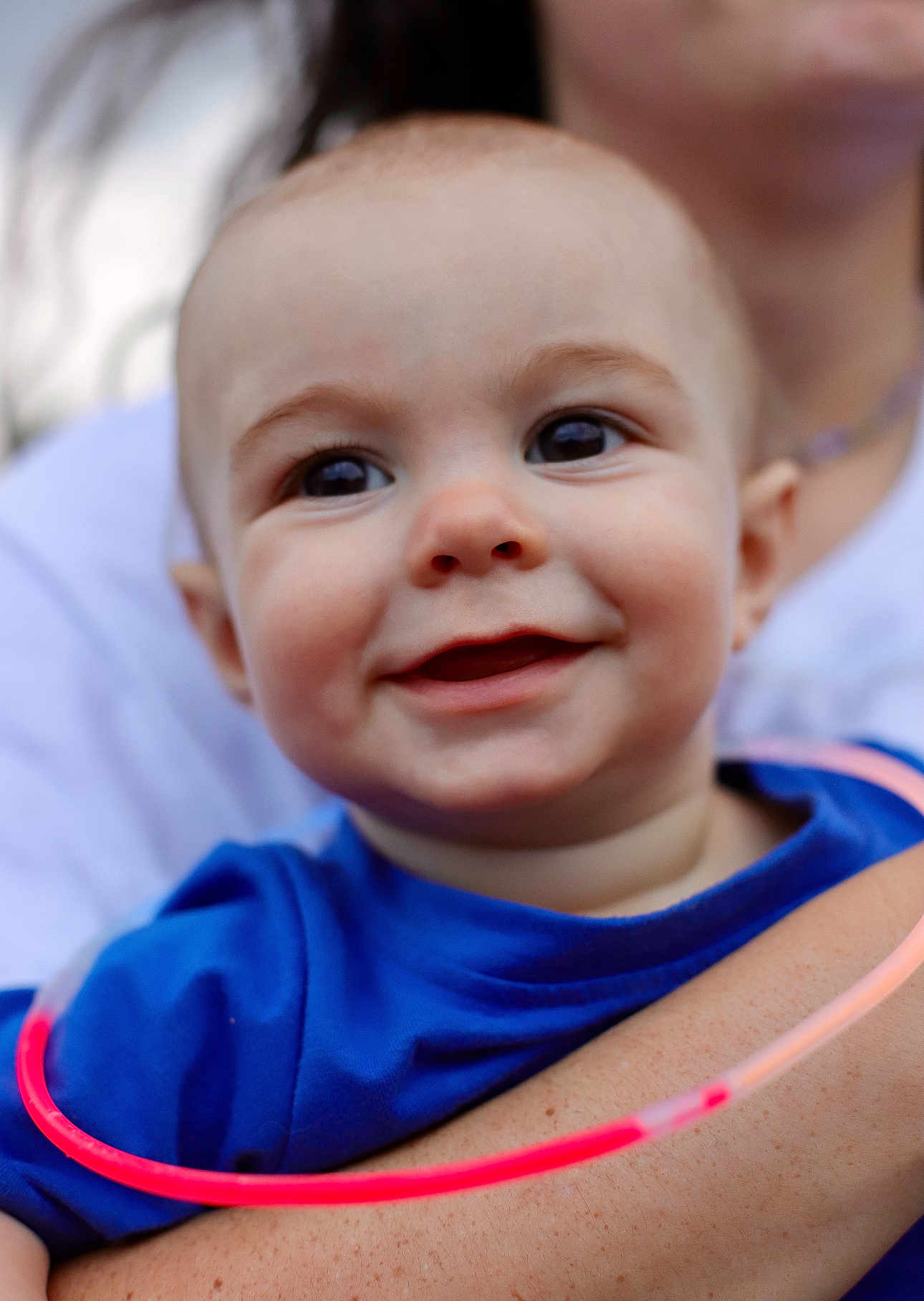 Levi joined the competition — help win amazing prizes! baby, child, smile, face, blue_shirt, arm, person, portrait, close_up, happy, skin, glowing_ring, neon, holding, parent, cute, young, expression, infant, human
