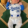baby, newborn, infant, baseball, sports_uniform, pacifier, glove, bat, blanket, lying_down, cute, child, rookie, striped_uniform, blue, white, sock, portrait, indoors, resting