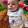 Oakley joined the competition — help win amazing prizes! baby, infant, child, play_seat, colorful, pacifier_clip, tommy_hilfiger, white_clothing, indoors, carpet, hand, face, blue_eyes, curious, cute, plush, toy, sitting, young, person