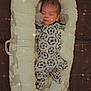 baby, sleeping, onesie, mittens, baby_lounger, cushion, sleep, face, infant, cozy, clothing, pattern, cute, rest, indoors, peaceful, sparkle_effect, portrait, child, soft