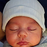 Ramone joined the competition — help win amazing prizes! baby, blanket, child, closeup, cozy, cute, eyelid, face, hat, headwear, indoors, infant, newborn, peaceful, portrait, resting, skin, sleeping, soft, young